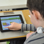 student at the harbor school using an ipad as part of their technology program for students with special needs