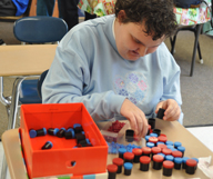 special education student demonstrating sorting skills in classroom