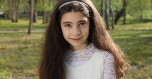 13 year old girl trying to smile